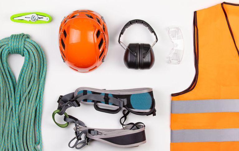 Various safety equipment such as hearing protection, a warning waistcoat and a helmet.